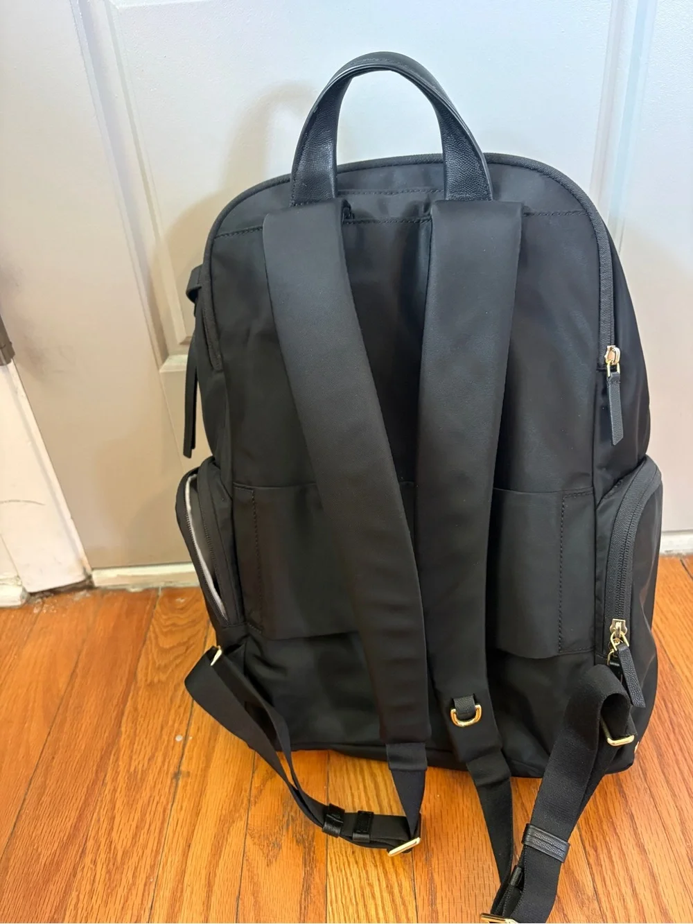 Tumi Voyageur Celina Black Backpack with Gold Hardware and Multiple Zip Pockets